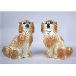 A PAIR OF STAFFORDSHIRE SPANIELS With glass eyes 