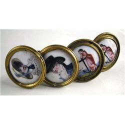 FOUR GILT METAL AND PORCELAIN TIE-BACKS Each 2 di