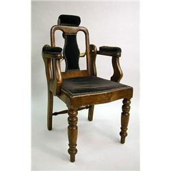 A WALNUT BARBER CHAIR With adjustable back and he