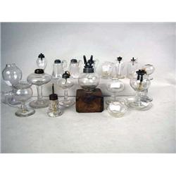 AN ASSORTED GROUP OF COLORLESS GLASS FLUID LAMPS 