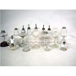 AN ASSORTED GROUP OF COLORLESS GLASS FLUID LAMPS 