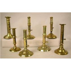 A GROUP OF SEVEN ASSORTED CAST-BRASS PUSH-UP HOGS