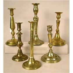 A GROUP OF EIGHT ASSORTED CAST-BRASS CANDLESTICKS