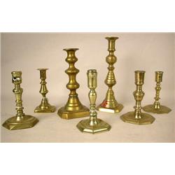 A GROUP OF SEVEN ASSORTED CAST-BRASS CANDLESTICKS