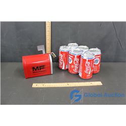 A 6 Pack of Coca-Cola Cans and A Tin Massey Ferguson Mailbox Coin Bank