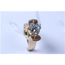 Lady's 14kt yellow gold and diamond ring set with three brilliant cut white diamonds