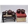 Image 1 : Set of Oriental purple clay tea items and a small "landscape stone" top tan wooden stand, 4" in heig