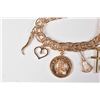 Image 2 : Lady's 10kt yellow gold charm bracelet set with 9 gold charms including pearl set, 10kt and 14kt gol