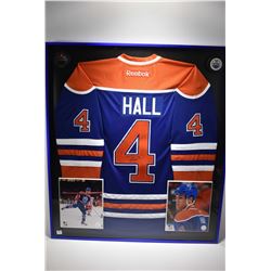 Shadow box framed handsigned blue and orange No. 4 Hull Oilers jersey with promo photos and pucks