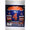 Image 1 : Shadow box framed handsigned blue and orange No. 4 Hull Oilers jersey with promo photos and pucks