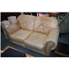 Image 1 : Genuine leather sand tone loveseat and matching armchair, both with large nail head decoration