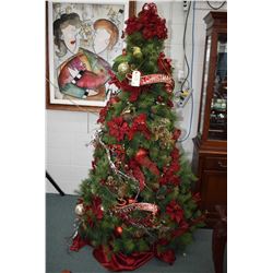 Fully decorated and illuminated artificial Christmas tree decorated at the Festival of Trees plus a