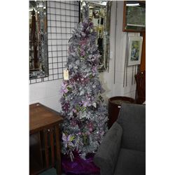 Fully decorated and illuminated artificial Christmas tree decorated at the Festival of Trees