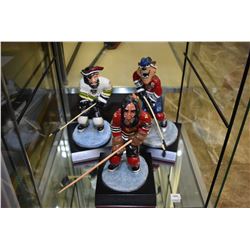 Three Van Mo handmade hockey caricature sculptures including Portland, Lethbridge and Prince Albert