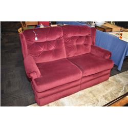 Two seater burgundy upholstered loveseat
