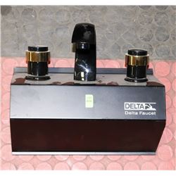 DELTA BLACK AND BRASS BATHROOM FAUCET