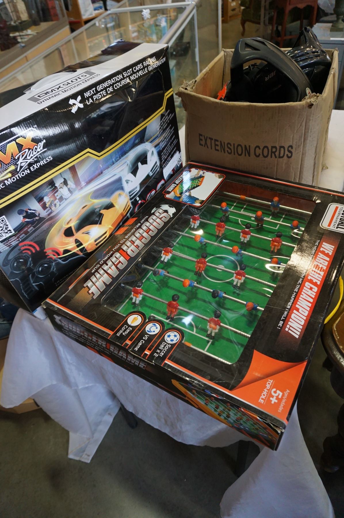 DMX RACER SLOT CAR SET, 3 HELMETS, AND MINI FOOSBALL GAME