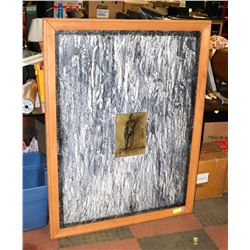 FRAMED ABSTRACT PICTURE WITH A PERSON IN CENTER.