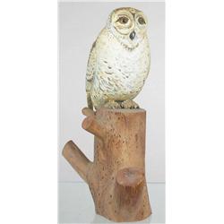 Standing snowy owl carving mounted on a section o