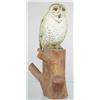 Image 1 : Standing snowy owl carving mounted on a section o