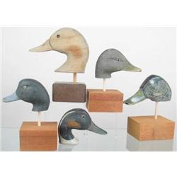 Lot of ten mounted antique decoy heads. Two goose