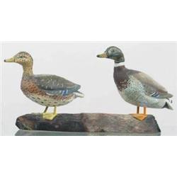 Miniature pair of mallards on a single driftwood 