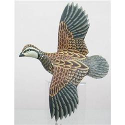 Lifesize flying quail with outstretched wings. Qu