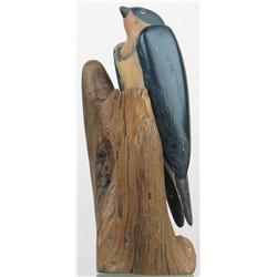 Early carving of a barn swallow with wings outlin