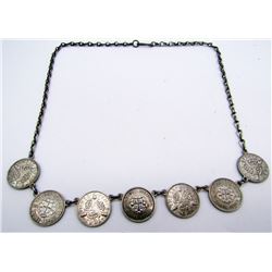STERLING NECKLACE WITH (7)FOREIGN COIN CHARMS