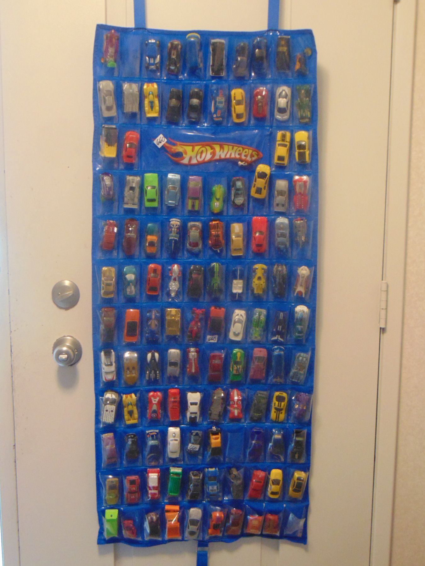 OVER 100 MATCHBOX CARS ON DOOR MOUNT RACK WITH SLEEVES