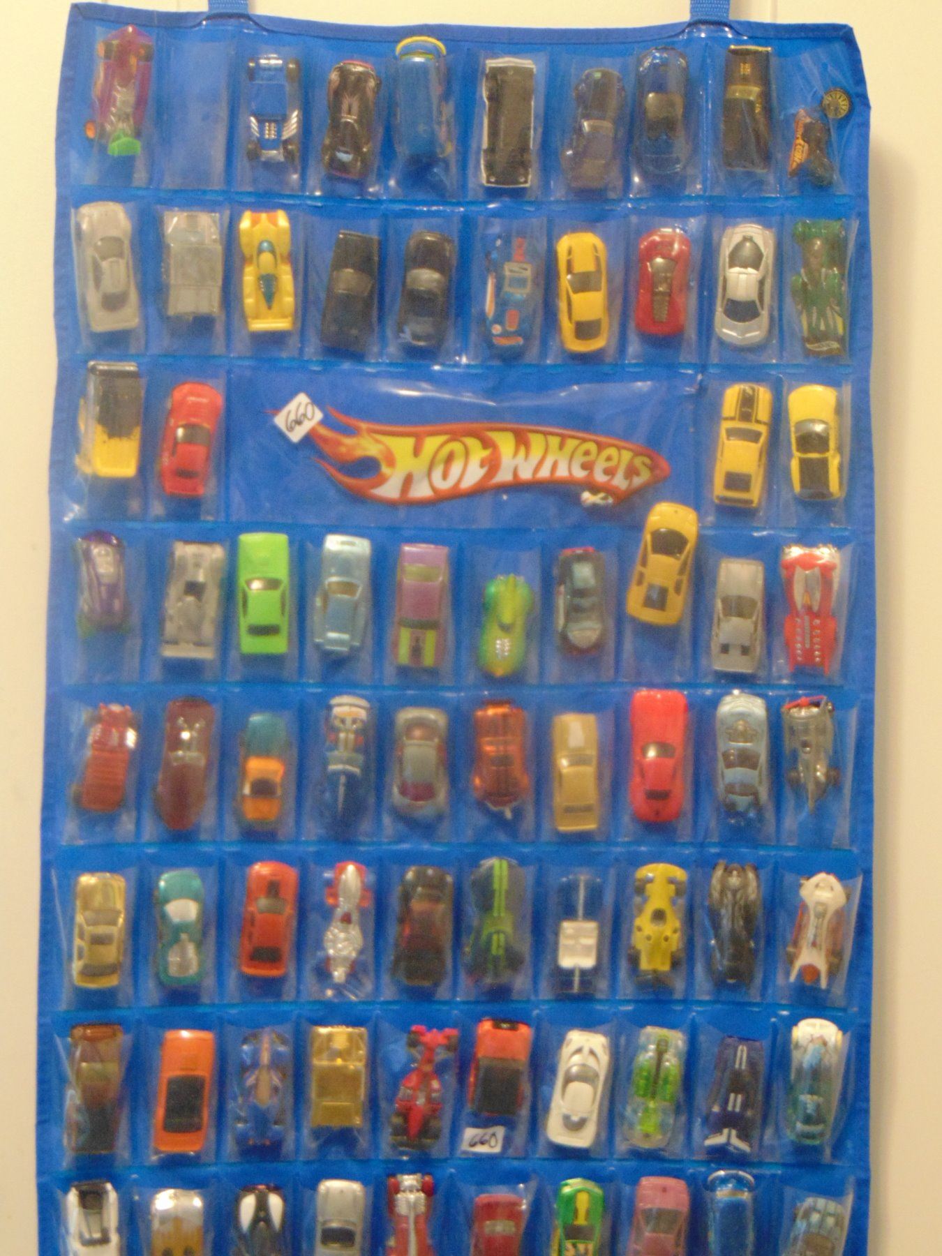 OVER 100 MATCHBOX CARS ON DOOR MOUNT RACK WITH SLEEVES