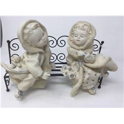 Figurines on a Bench