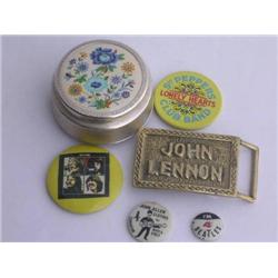 The Beatles: 3 pin badges, a John Lennon brass belt buckle and an unusual powder compact with a Paul