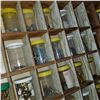 Image 9 : WOOD HARDWARE ORGANIZER FULL OF JARS OF HARDWARE AND RED TOTE OF HARDWARE