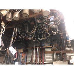 LARGE QUANTITY OF ASSORTED BELTS ON WALL/CEILING