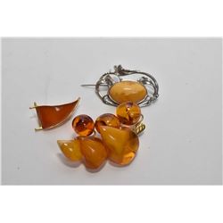 Three amber brooches including Baltic amber and gold plate brooch, Nouveau style silver brooch, and 
