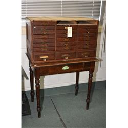 Multi-draw document section of a barrister's stacking bookcase including seventeen drawers with one 