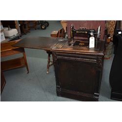 Antique Eaton treadle sewing machine in fully enclosed oak cabinet