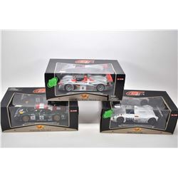 Three new in box 1:18 scale Maisto die cast collector cars including Audi R8, Porsche 911 GT1 and a 