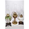 Image 1 : Two vintage oil lamps with glass painted fonts plus a brass oil lamp, all with clear chimneys