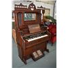 Image 1 : Antique pump organ made by Bell Organ and Piano Company with tall decorative back and bevelled mirro