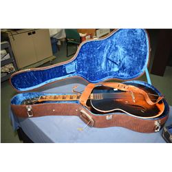 Two vintage musical instruments including a Melody King six string guitar in hard case and a violin