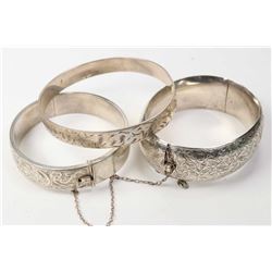 Three vintage chaised bracelet including a Birks hinged bracelet with British hallmarks, a silver ba