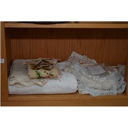 Shelf lot of vintage table linens including table linens, embroidered pieces, napkins etc.