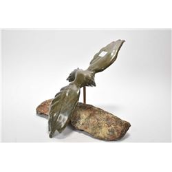 Stone Inuit carving of a bird in flight on a stone base, 14" wing span