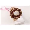 Image 1 : Vintage 10kt yellow gold, garnet and opal ring set with 0.96ct of round facet garnets and an oval sh