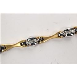 Ladies 18kt yellow and white gold diamond bracelet set with .33ct of round full cut white diamonds. 