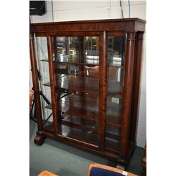 Antique flame mahogany display cabinet with decorative column support and full 90 degree bend glass 