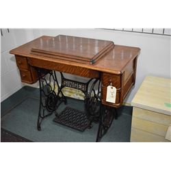 Antique Singer treadle sewing machine in oak and metal cabinet