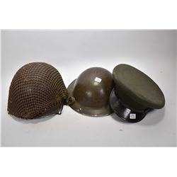 Two military helmets and an officer's hat